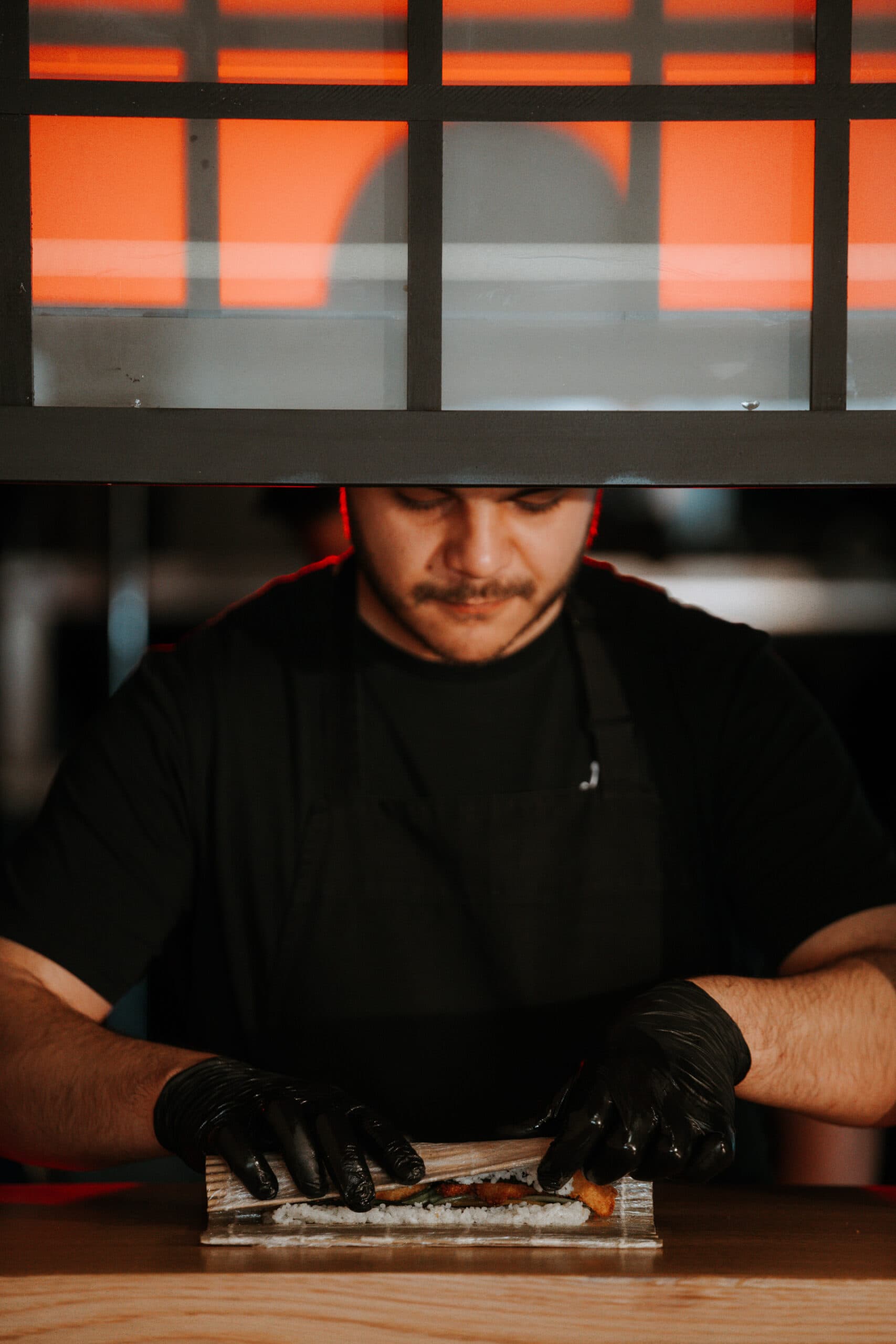 Chef crafting sushi behind the bar